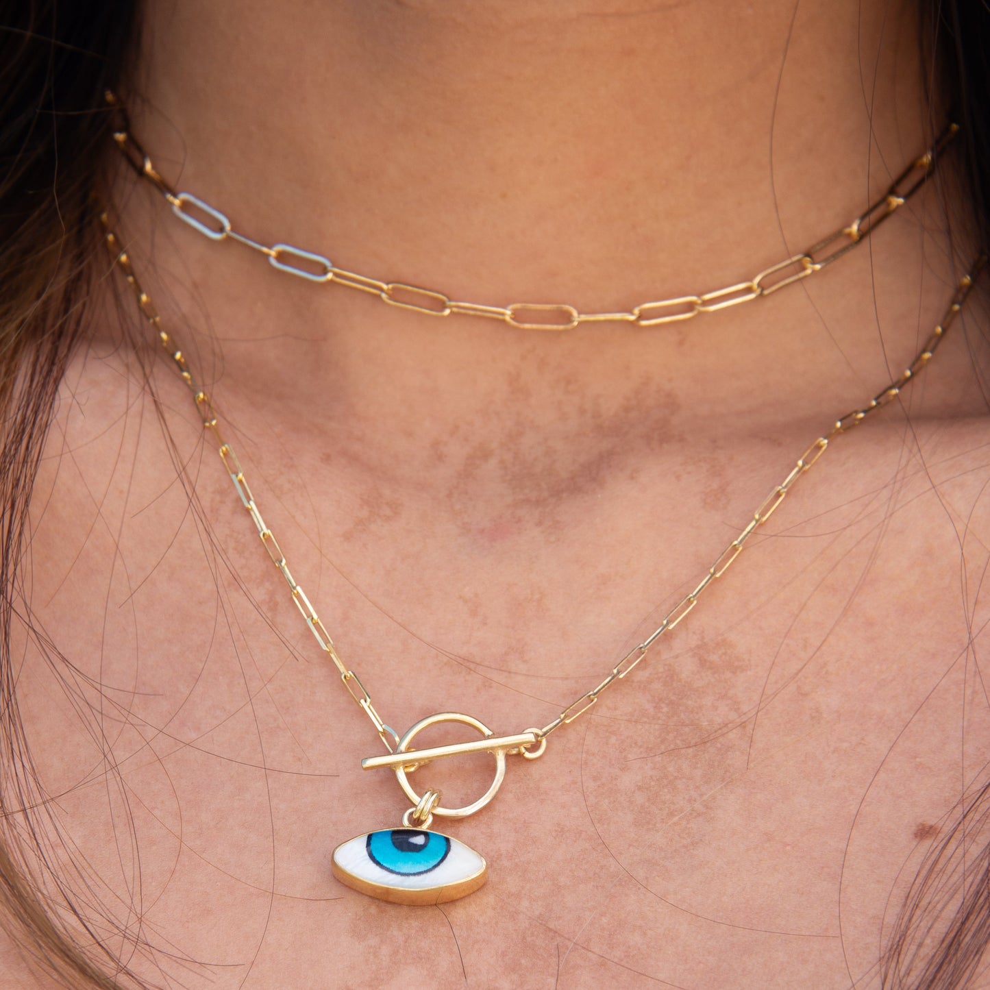 Adrano Eye Pendant and Paperclip Chain Necklace in 18K Gold Plated 925 Sterling Silver on a woman's neck.