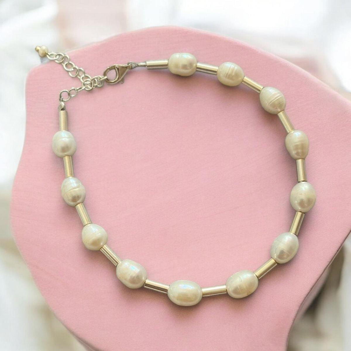 Aida freshwater pearl and 925 sterling silver bracelet on pink background, elegant jewellery piece.