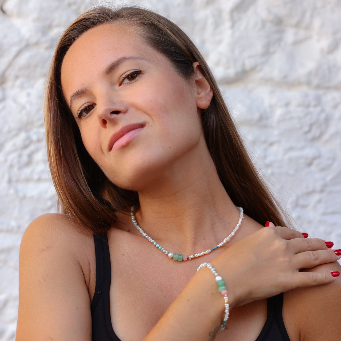 Woman wearing Andria Pearl & Turquoise Gemstone Necklace with matching bracelet