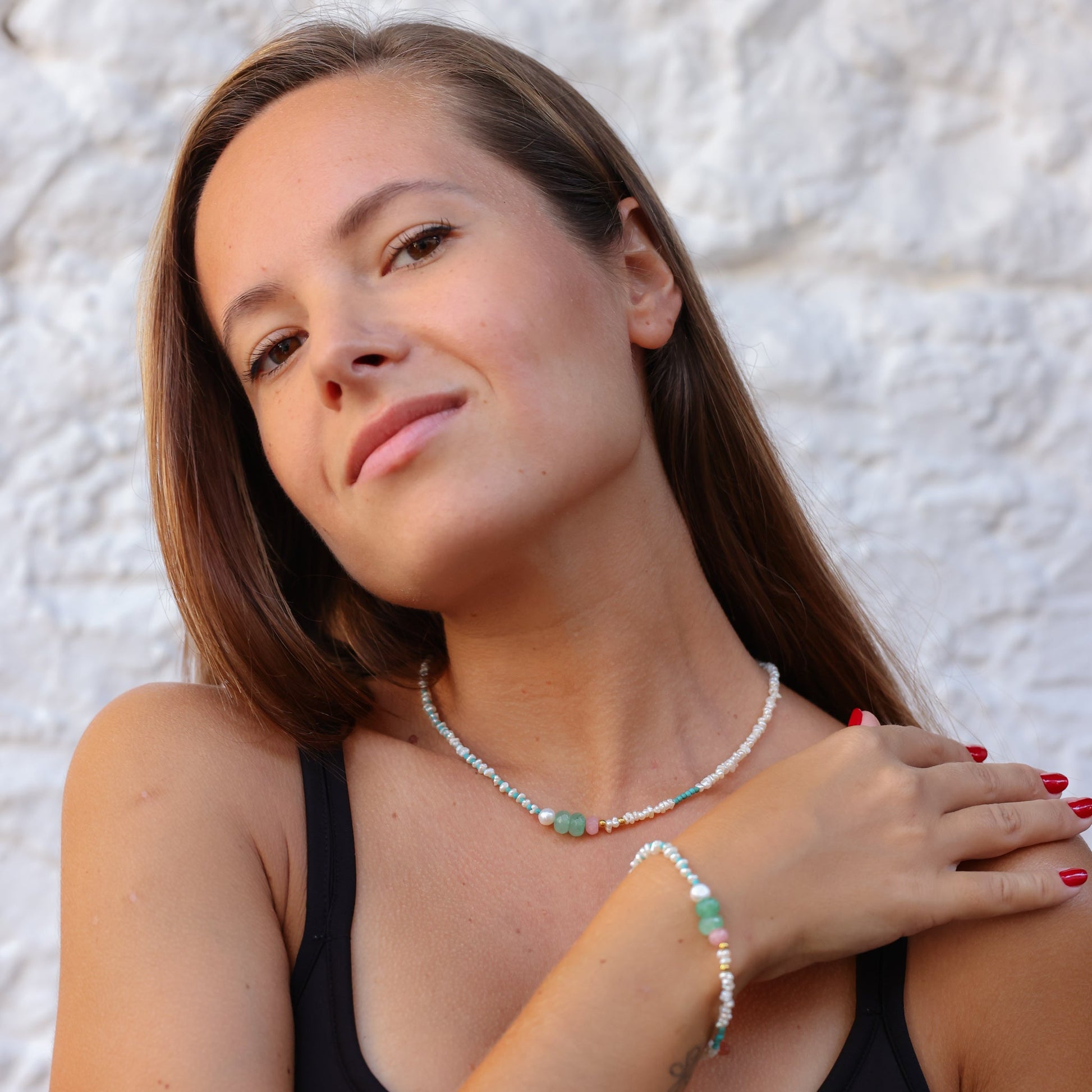 Woman wearing Andria Pearl & Turquoise Gemstone Necklace with matching bracelet