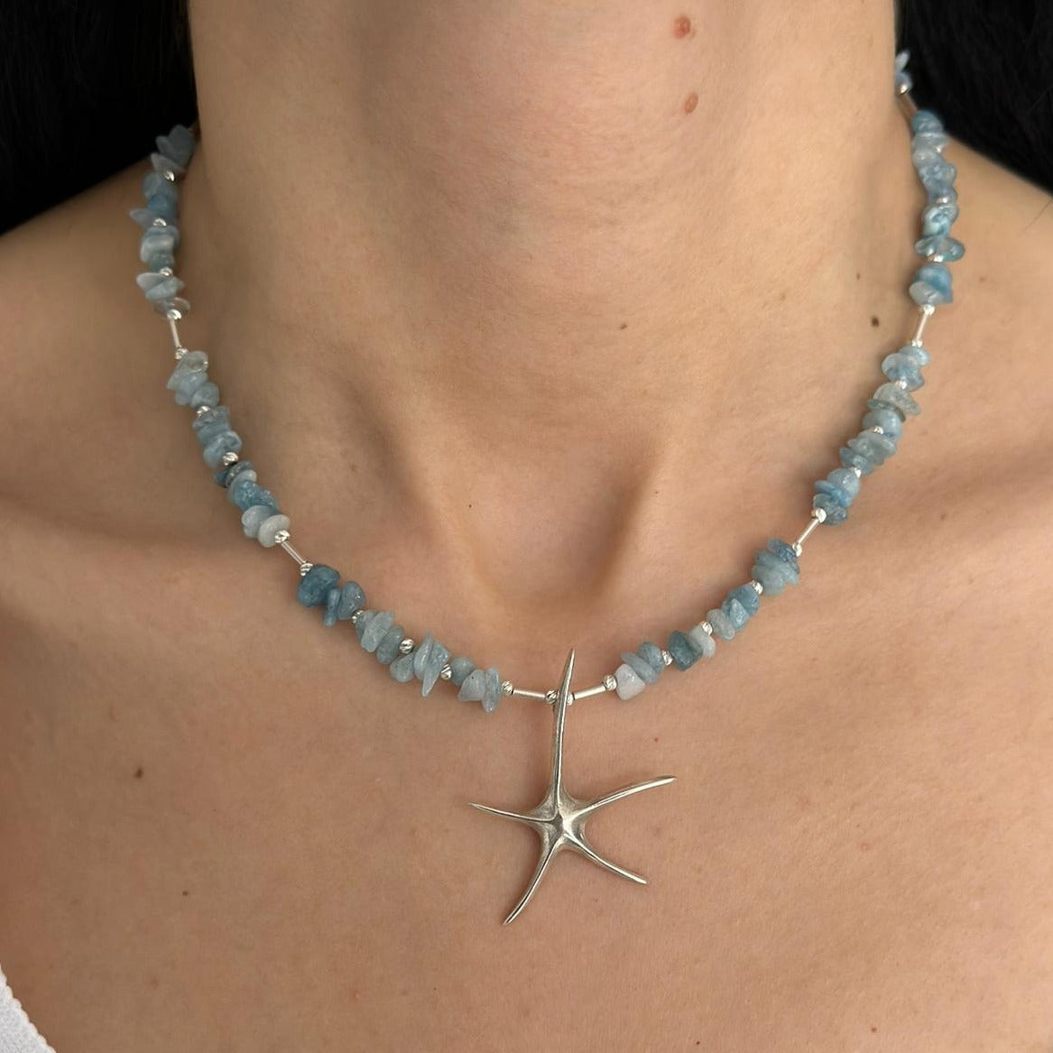 Aquamarine Starfish Necklace in 925 Silver - Handmade Elegance displayed on a woman's neck.