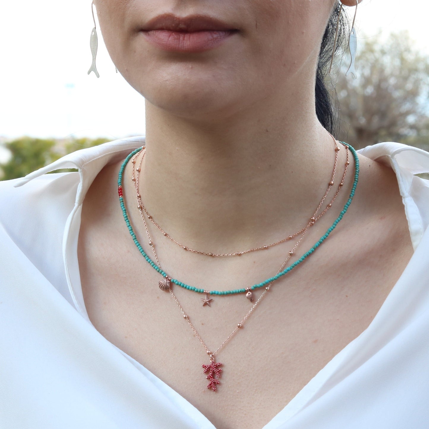 Close-up of a woman wearing Atlantis Minimal Howlite Gemstone and Silver Necklace.