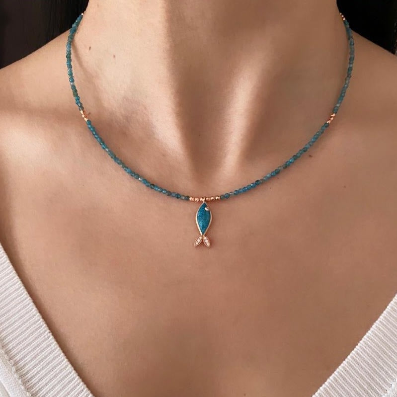 Azure Apatite Gemstone Fish Necklace on a woman's neck