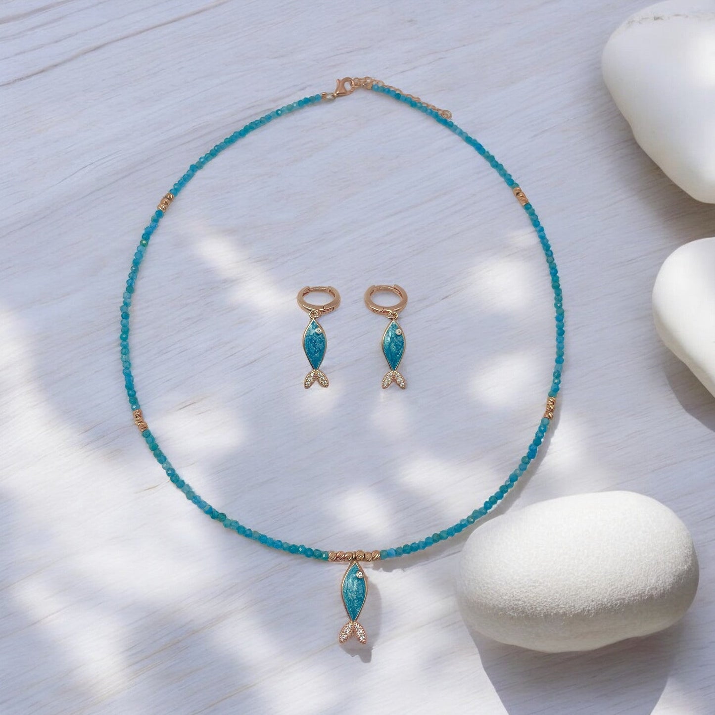 Azure Apatite Gemstone Fish Necklace with Matching Earrings on White Surface