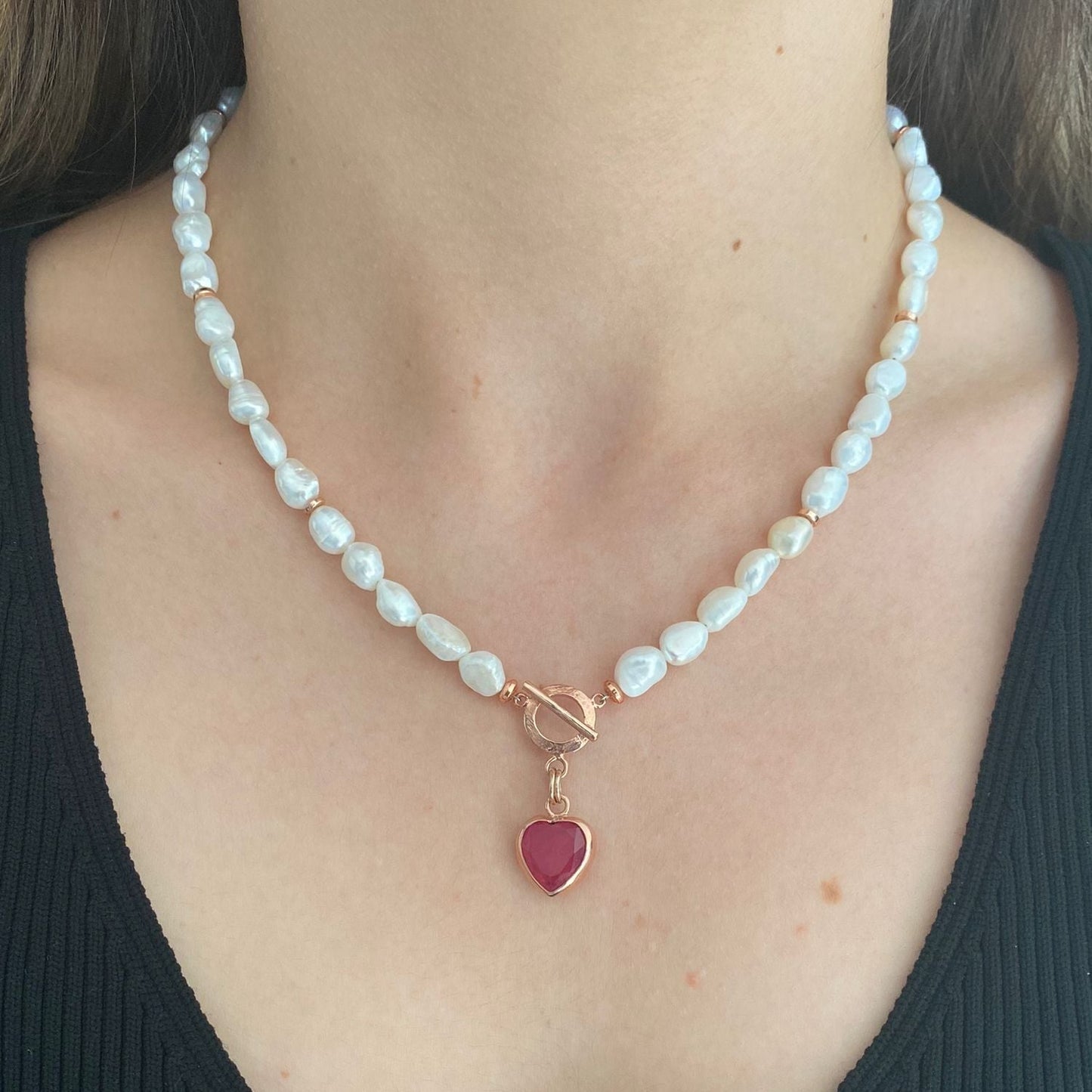 Baroque Pearl Heart Necklace featuring white baroque pearls and a red heart pendant with gold clasps.