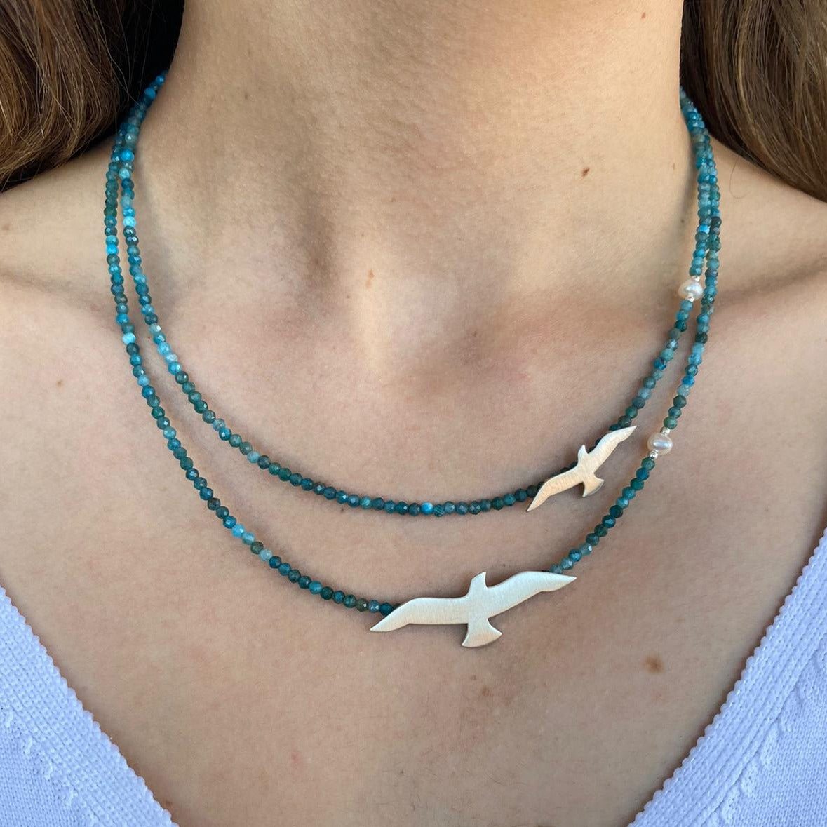 Close-up of Big and Small Seagull Apatite Silver Necklace worn on a neck.