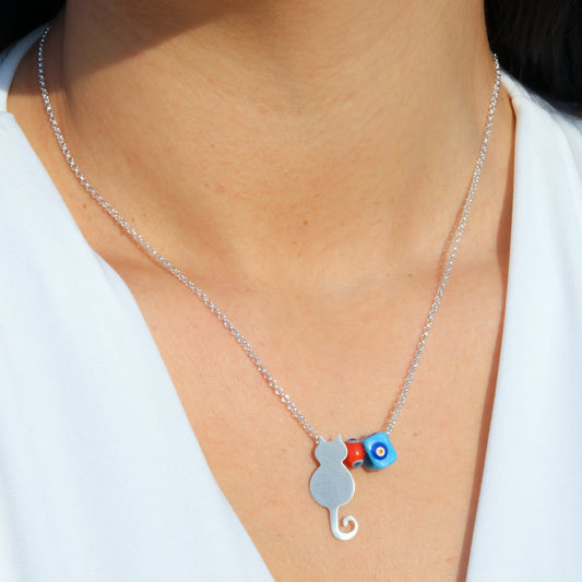 Close-up of Cat and Evil Eye Silver Necklace worn by a person