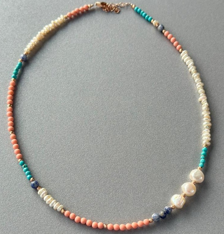 Comiso Pearl and Gemstones Necklace with multicolor beads and pearls on a grey background