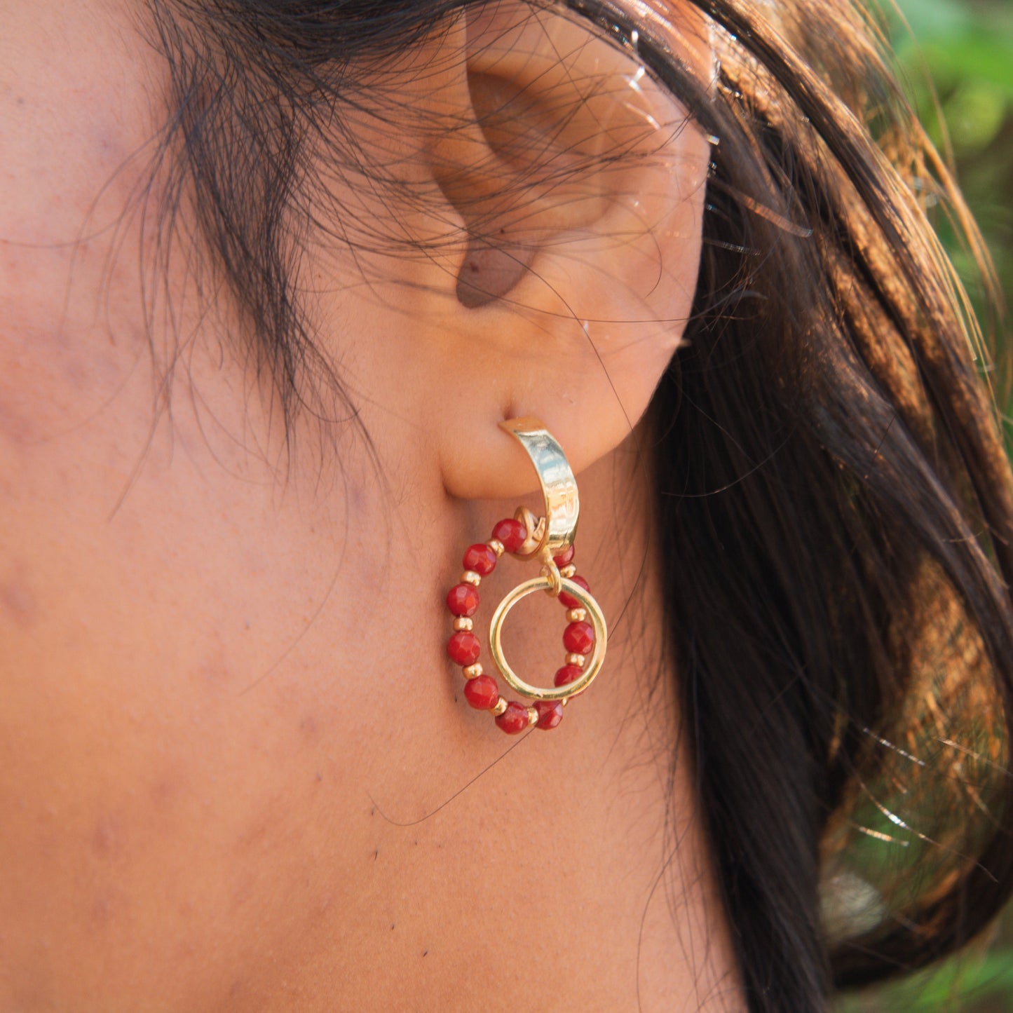 Close-up of Coral Gemstone Earrings in 925 Sterling Silver with 14K Gold Plating worn by a woman