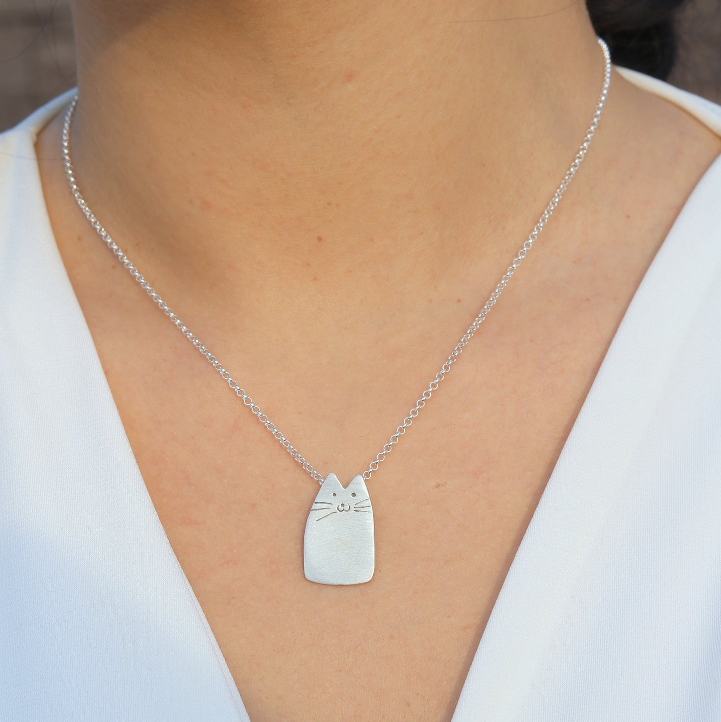 Cutie Cat Silver Necklace on woman's neck