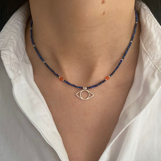 Eye Sterling Silver and Lapis Necklace on a person wearing a white collared shirt