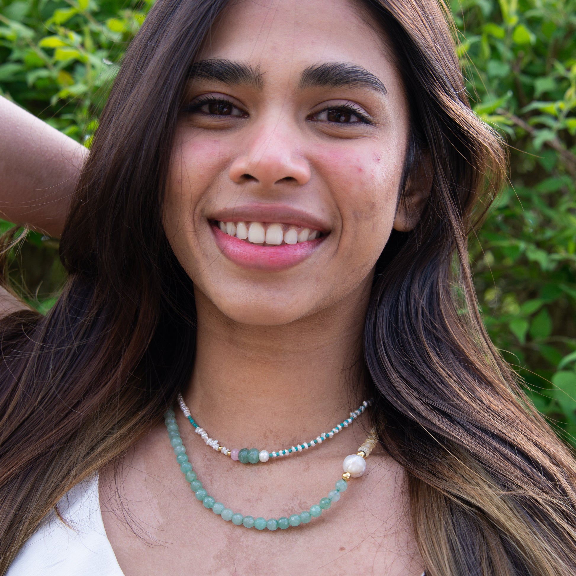 Smiling woman wearing Foligna Aventurine and Citrine Gemstone Beaded Necklace