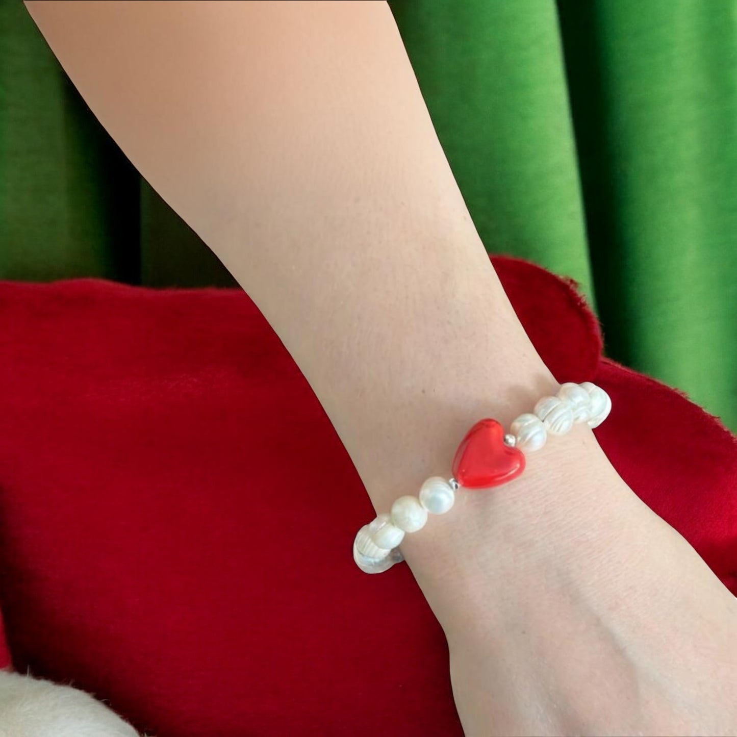 Elegant freshwater pearl bracelet featuring a striking red glass heart, perfect for a romantic gesture or gift.