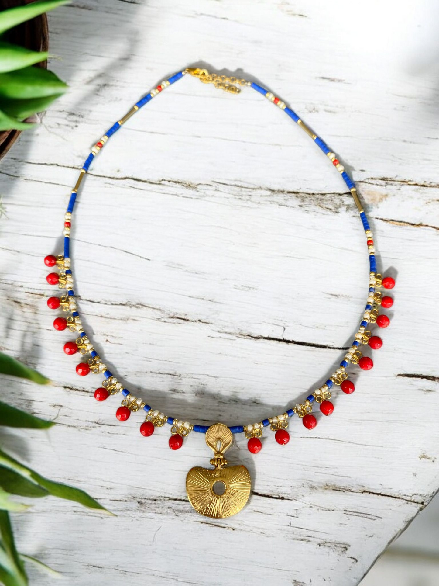 Hera Coral and Lapis Lazuli Gemstone Necklace in 925 Silver with Gold Plating featuring vibrant red coral beads and a gold pendant on a blue gemstone chain