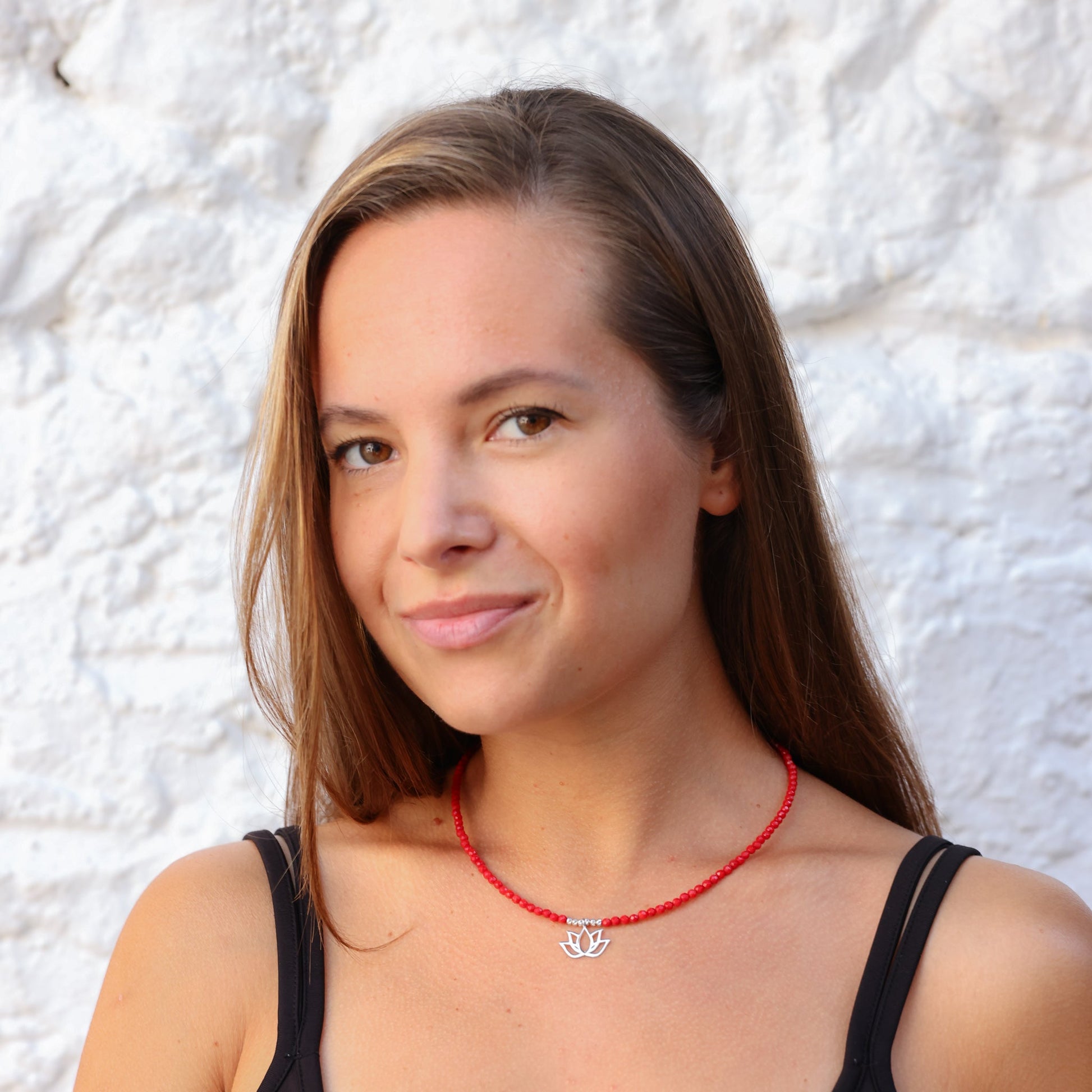 Woman wearing a Lotus Flower Coral Gemstone Beaded Necklace