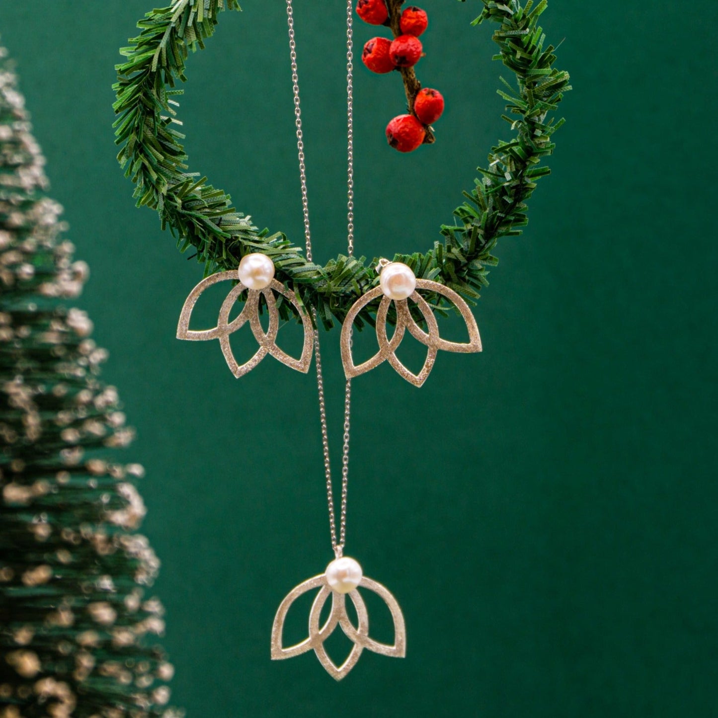 Lotus Flower Silver and Freshwater Pearl Necklace and Earrings Set adorned on green holiday wreath with red berries.