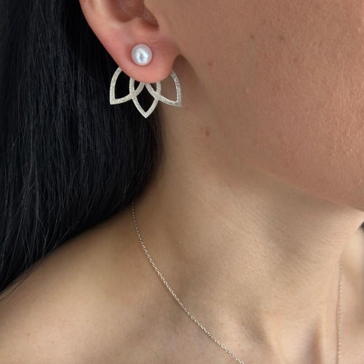 Close-up of a woman wearing a Lotus Flower Silver and Freshwater Pearl Necklace and Earrings Set