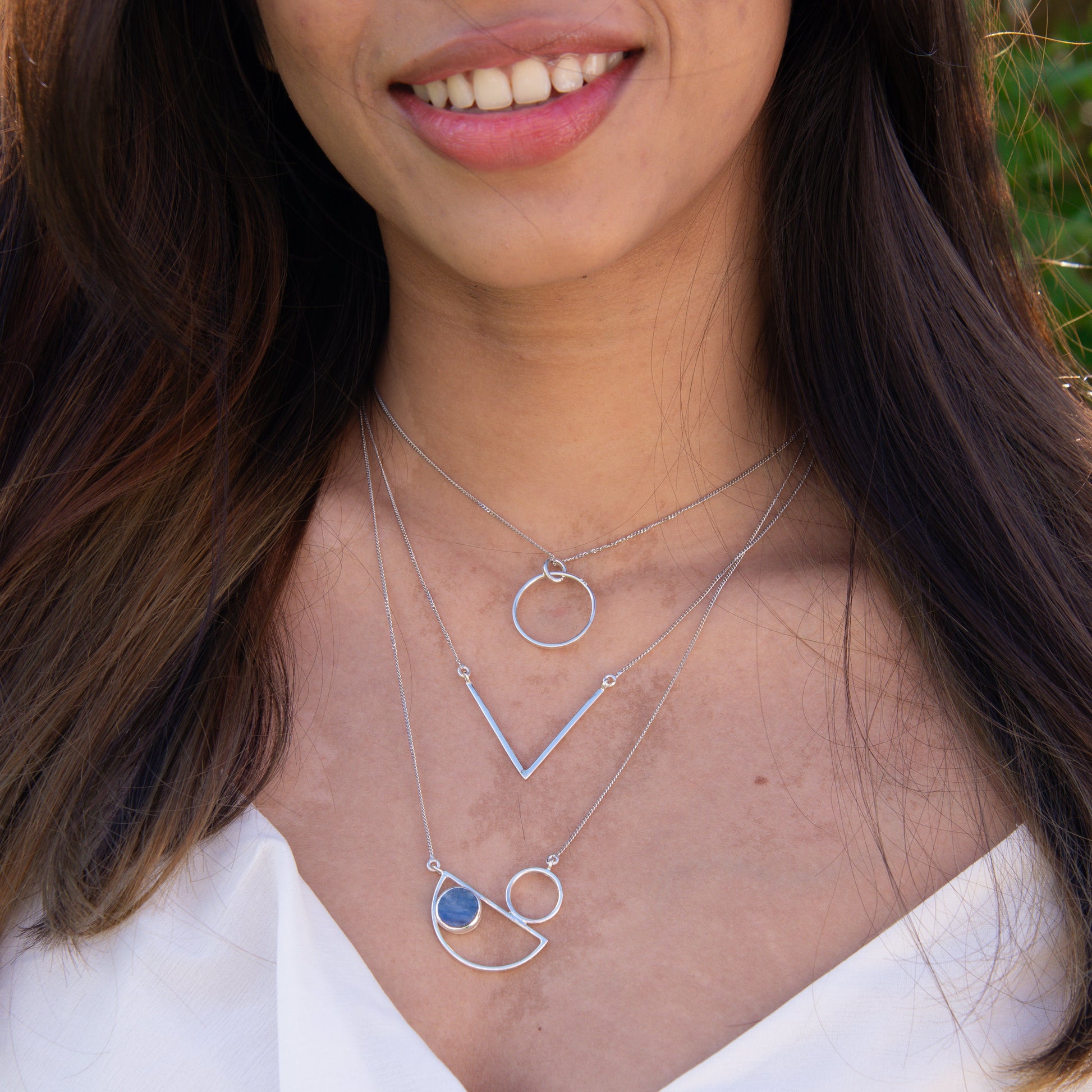 Messina Layered Silver Necklace Set showcased on a woman wearing a white top