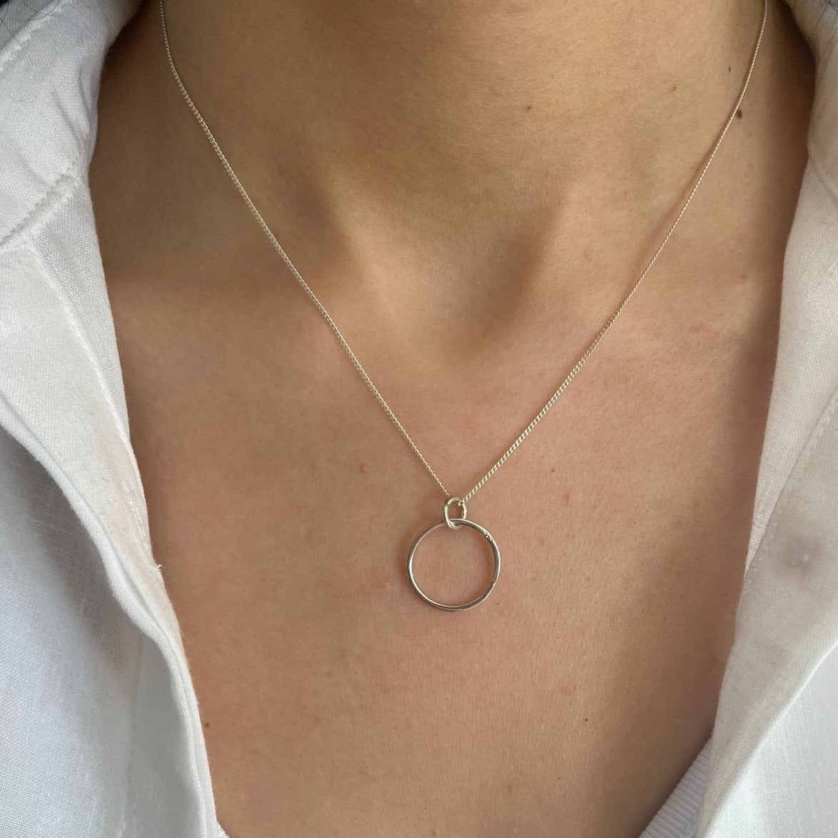 Messina Layered Silver Necklace Set featuring a minimalist circular pendant on a delicate silver chain.