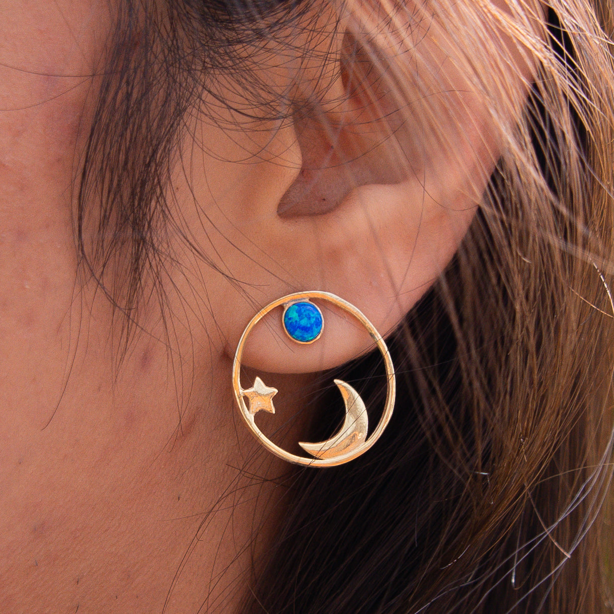 Close-up of My World Silver Earrings with star, moon, and blue gemstone details.