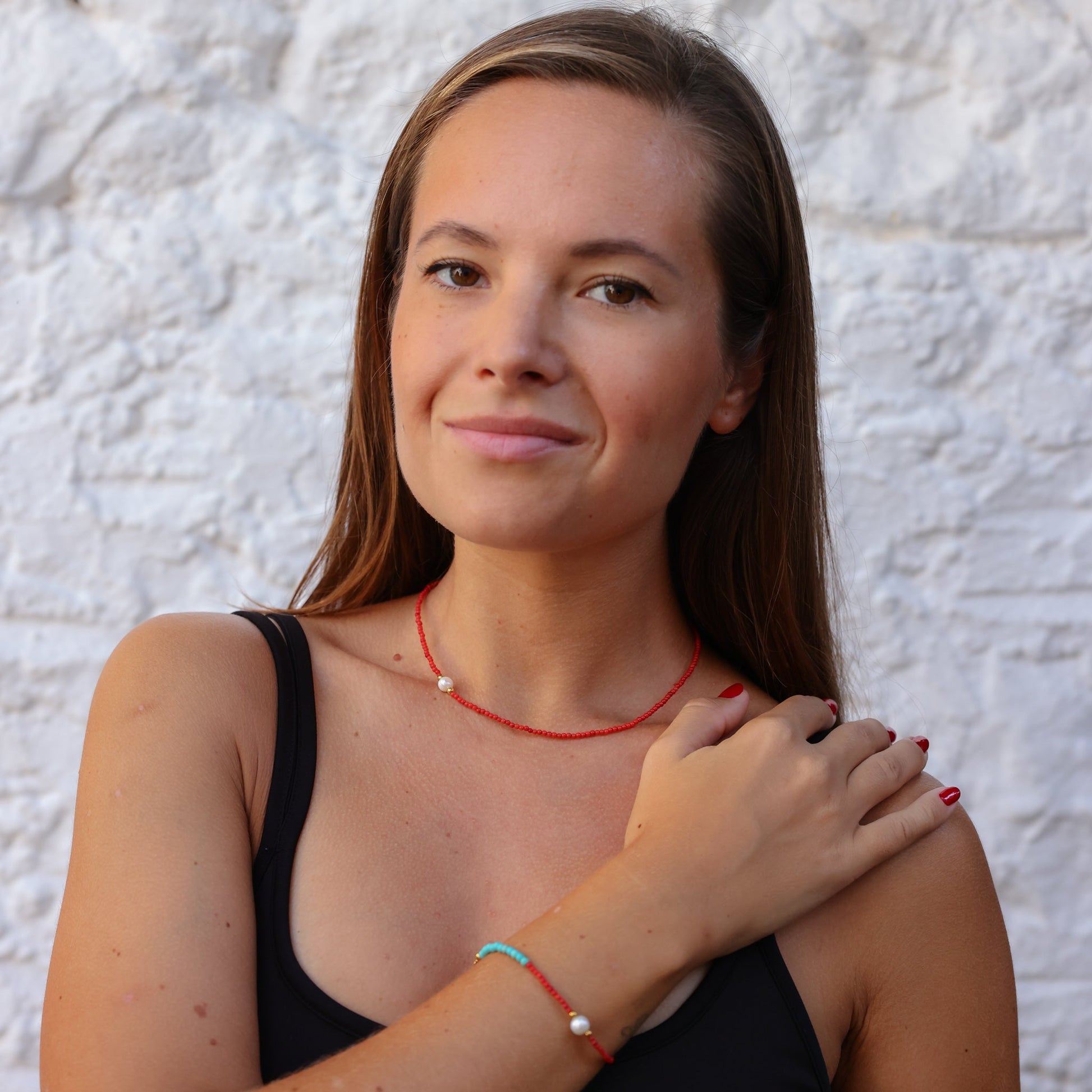 Woman wearing Nola Coral & Turquoise Beaded Necklace with white bead accent