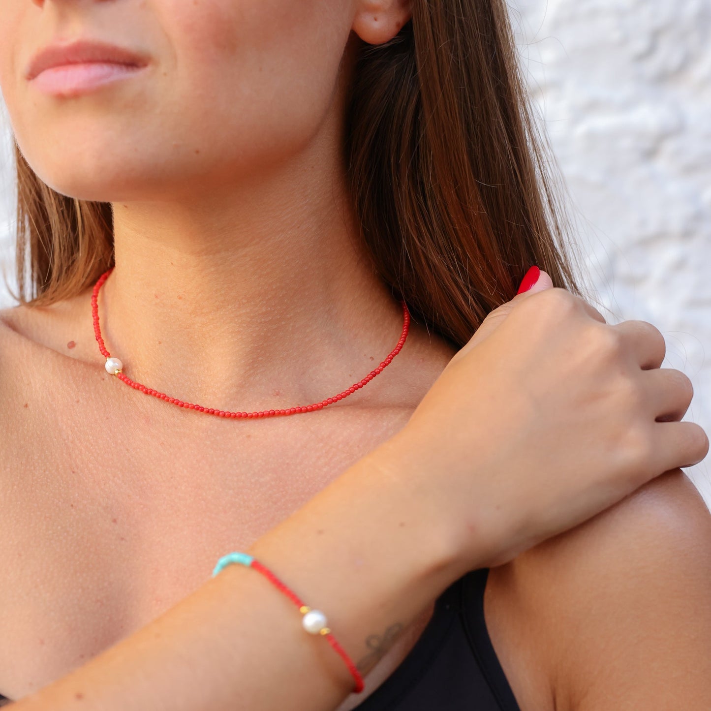 Woman wearing Nola Coral & Turquoise Beaded Necklace with matching bracelet