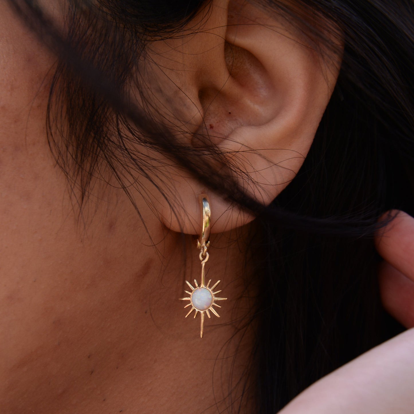 North Star Moonstone Dangle Drop Earrings on a woman's ear