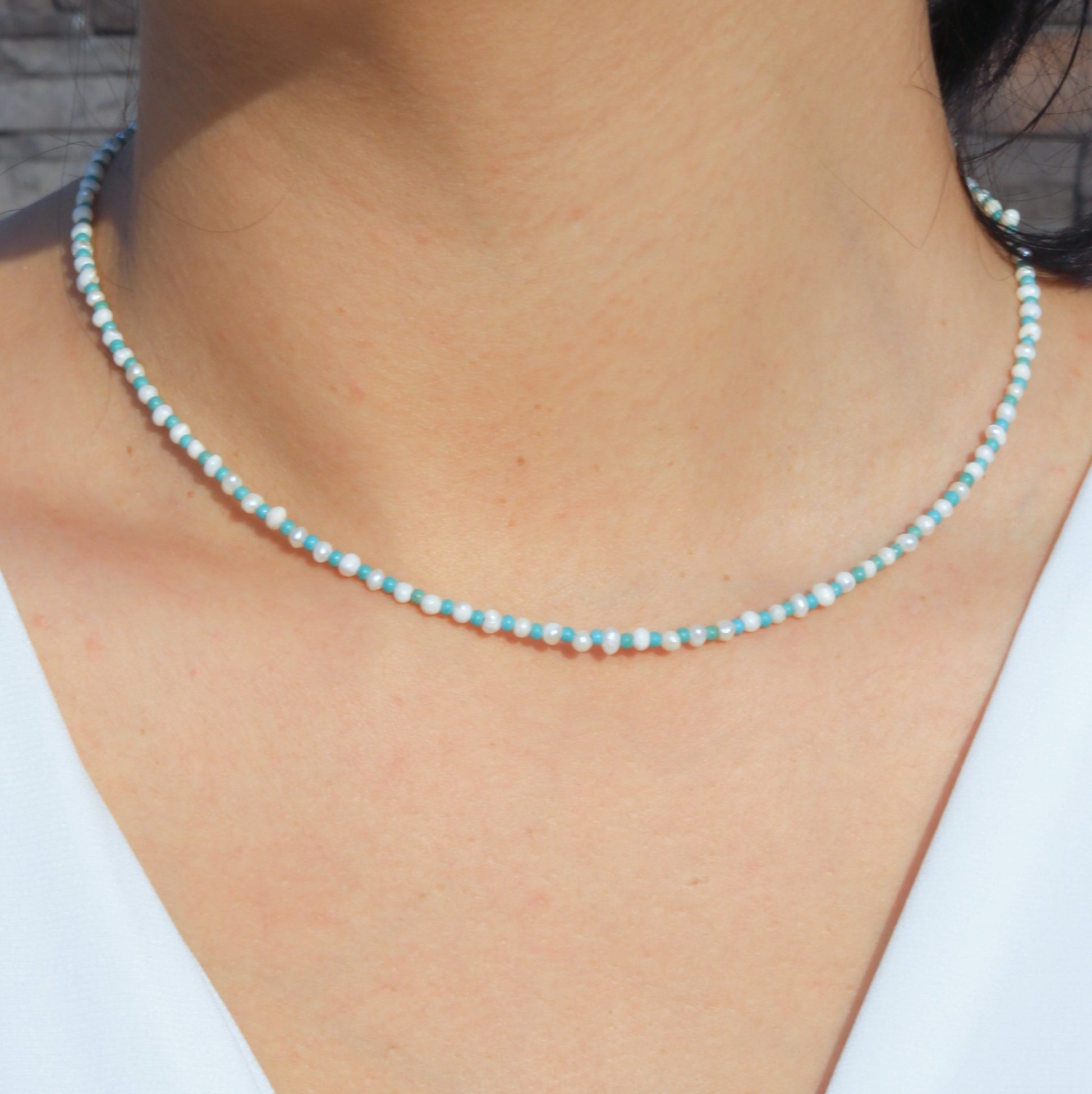 Close-up of a Pearl and Blue Howlite Gemstone Beaded Necklace worn around the neck