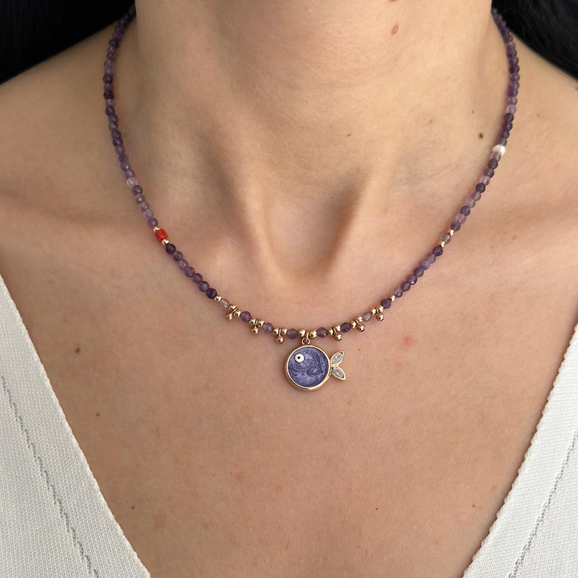 Close-up of Phuket Amethyst Fish Pendant Necklace in Rose Gold Plated Sterling Silver worn around a woman's neck