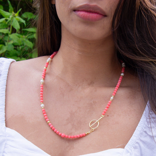 Pink Coral Gemstone Necklace with Baroque Freshwater Pearls worn by a woman in white top