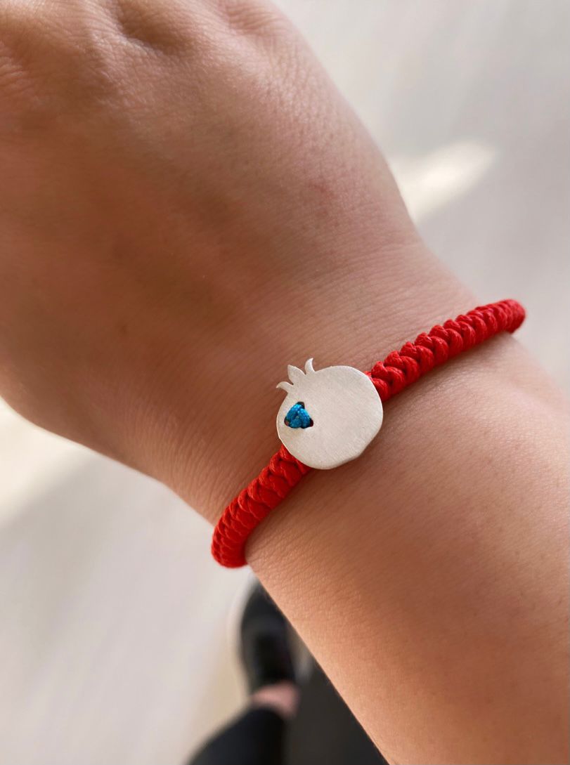 Elegant Pomegranate Silver Bracelet with Red Cord and Blue Accent