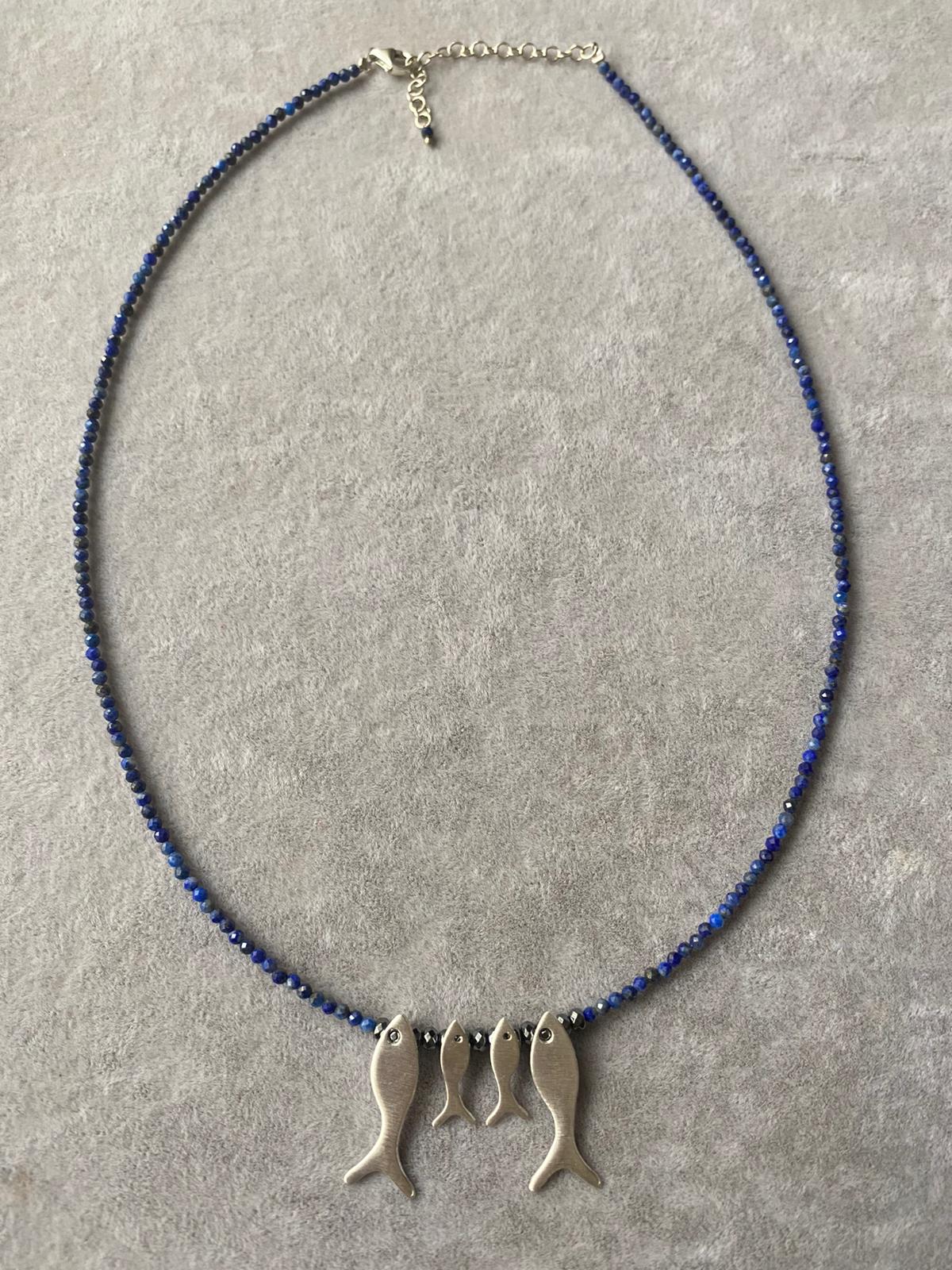 Quartet Fish Family Lapis Necklace featuring four silver fish pendants on a strand of blue lapis beads