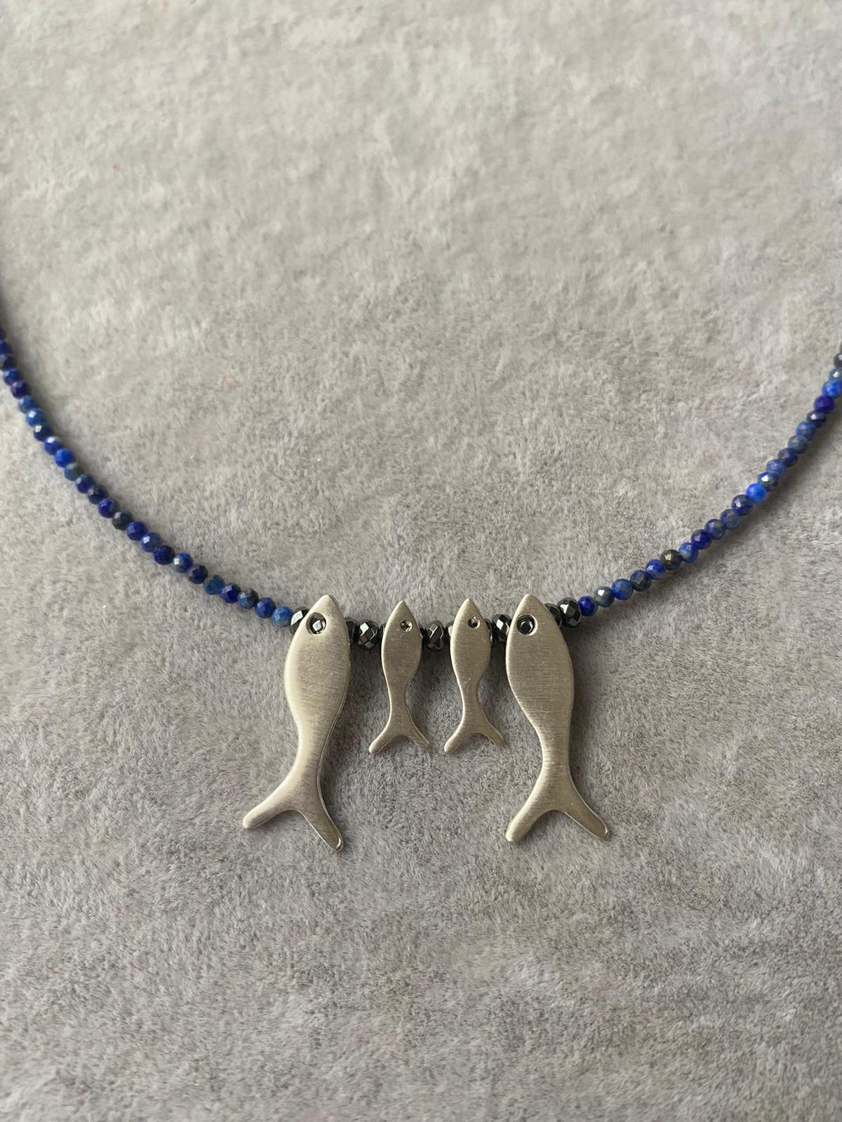 Quartet Fish Family Lapis Necklace featuring four fish-shaped pendants on a blue gemstone beaded chain