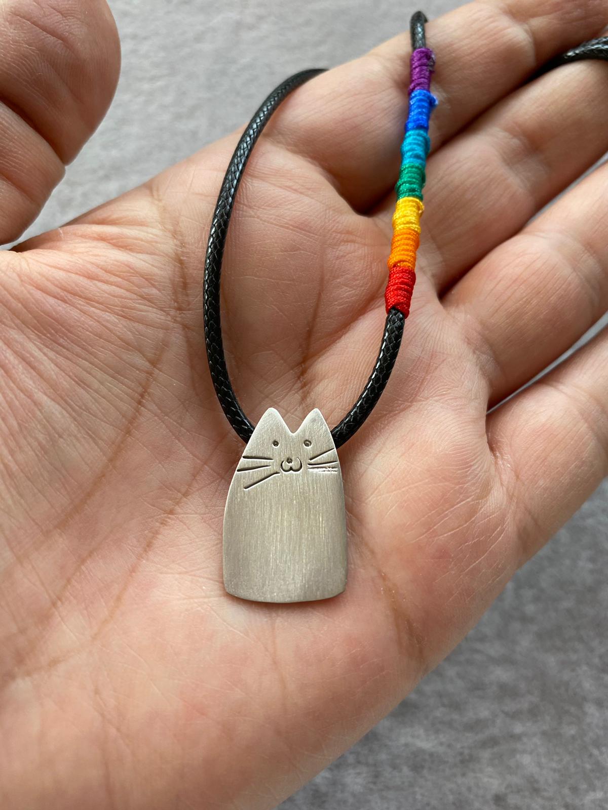 Rainbow Cutie Cat Silver Cord Necklace with a silver cat charm on a black cord with a rainbow section.