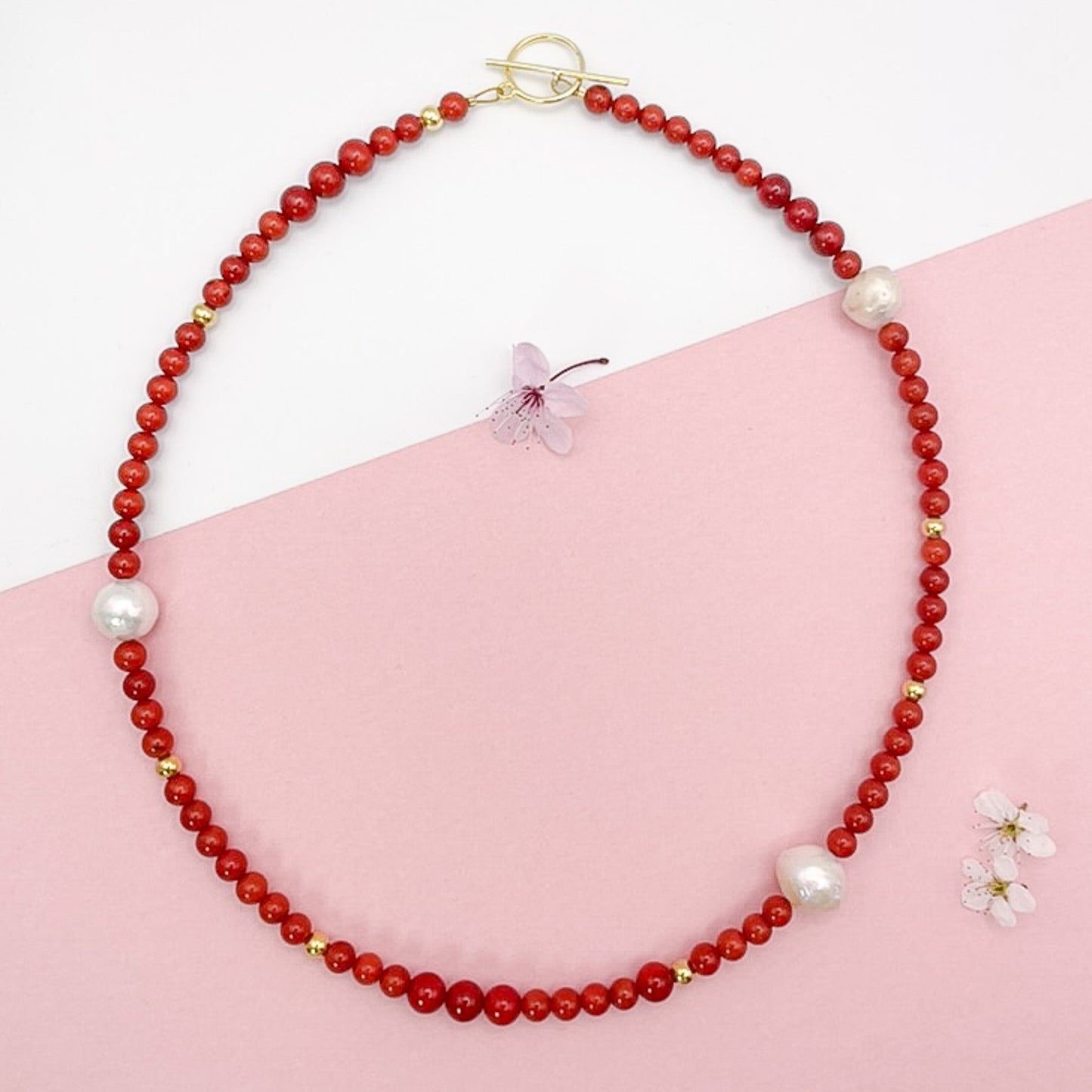 Red Coral Gemstone Necklace with Baroque Freshwater Pearls on a pink backdrop