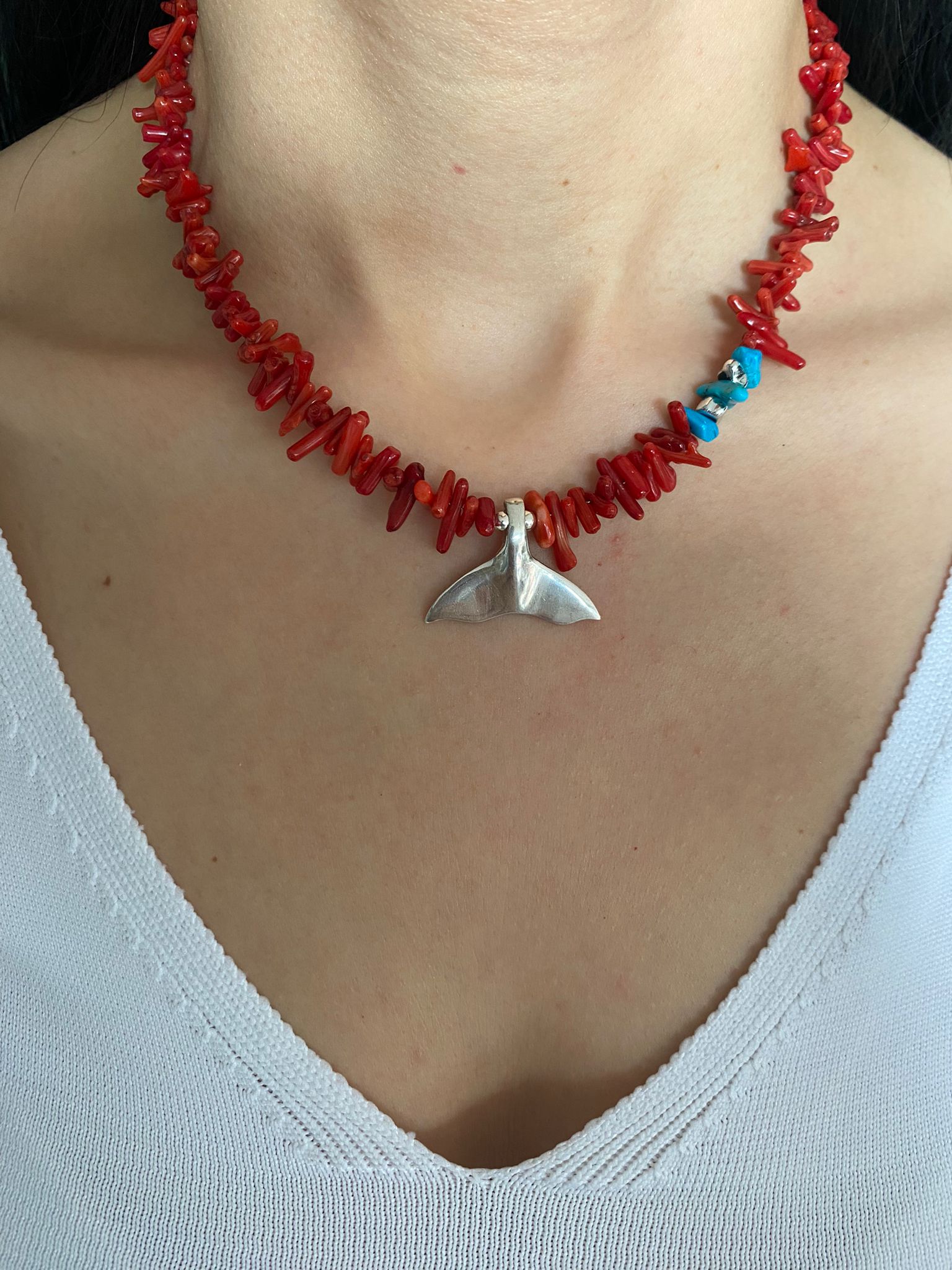 Reef Coral Gemstone Silver Fish Tail Necklace on a model's neck