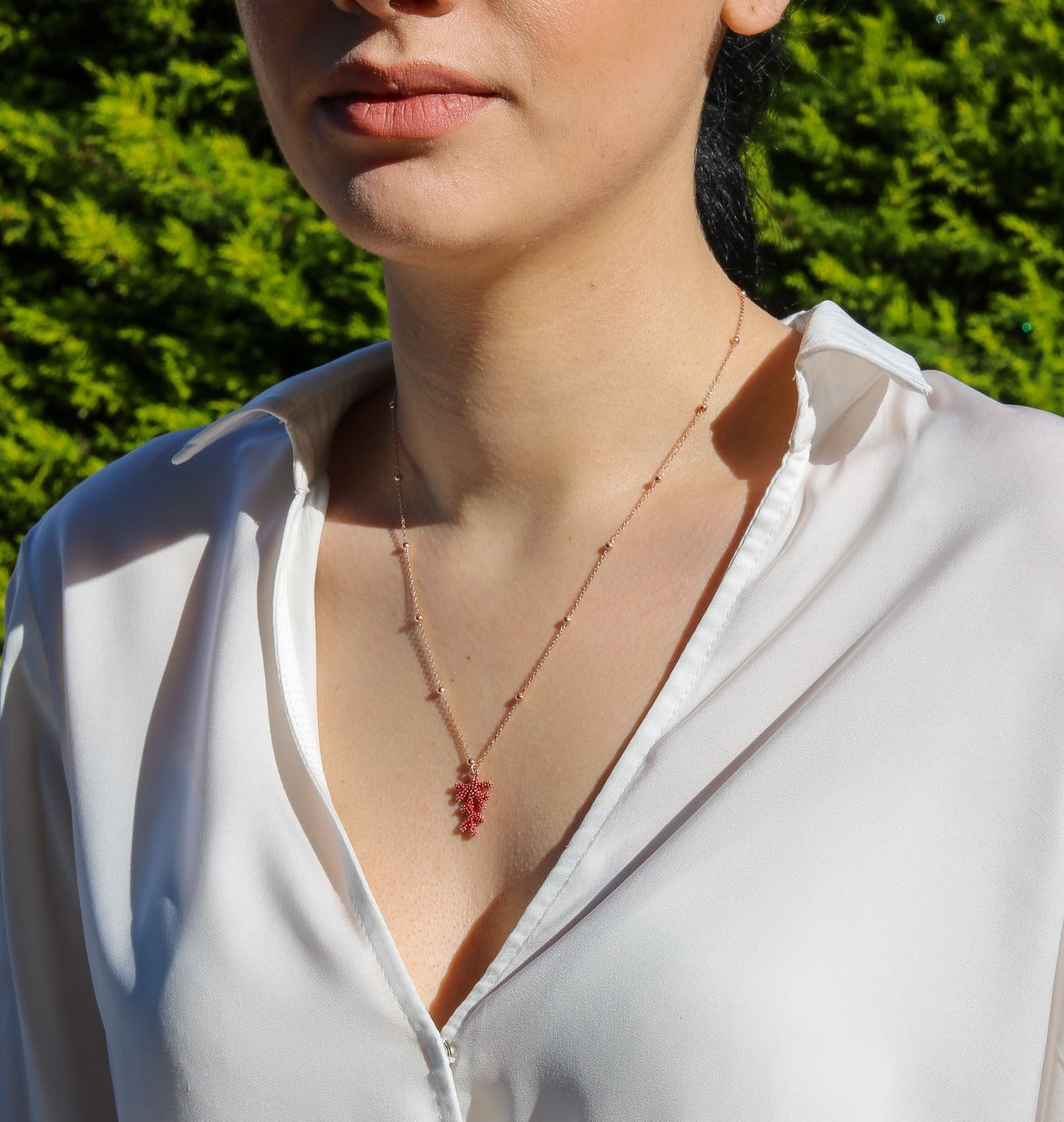 Woman wearing a Rose Gold Plated Silver Chain with a delicate Red Coral Pendant