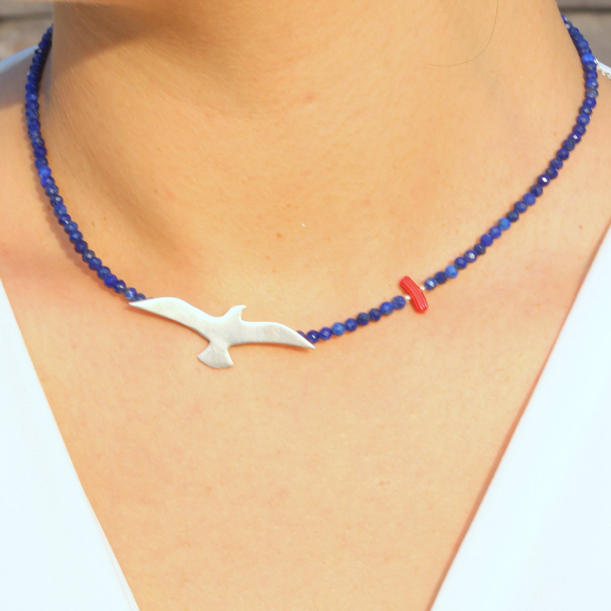 Seagull Lapis Lazuli Gemstone Necklace adorned on a person's neck