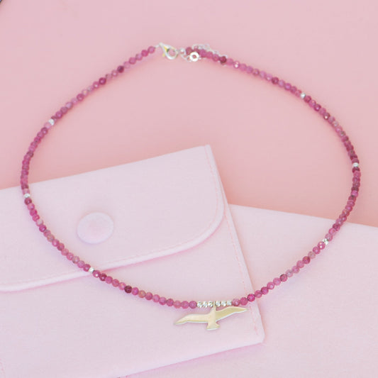 Seagull Pink Tourmaline Necklace displayed on a pink background