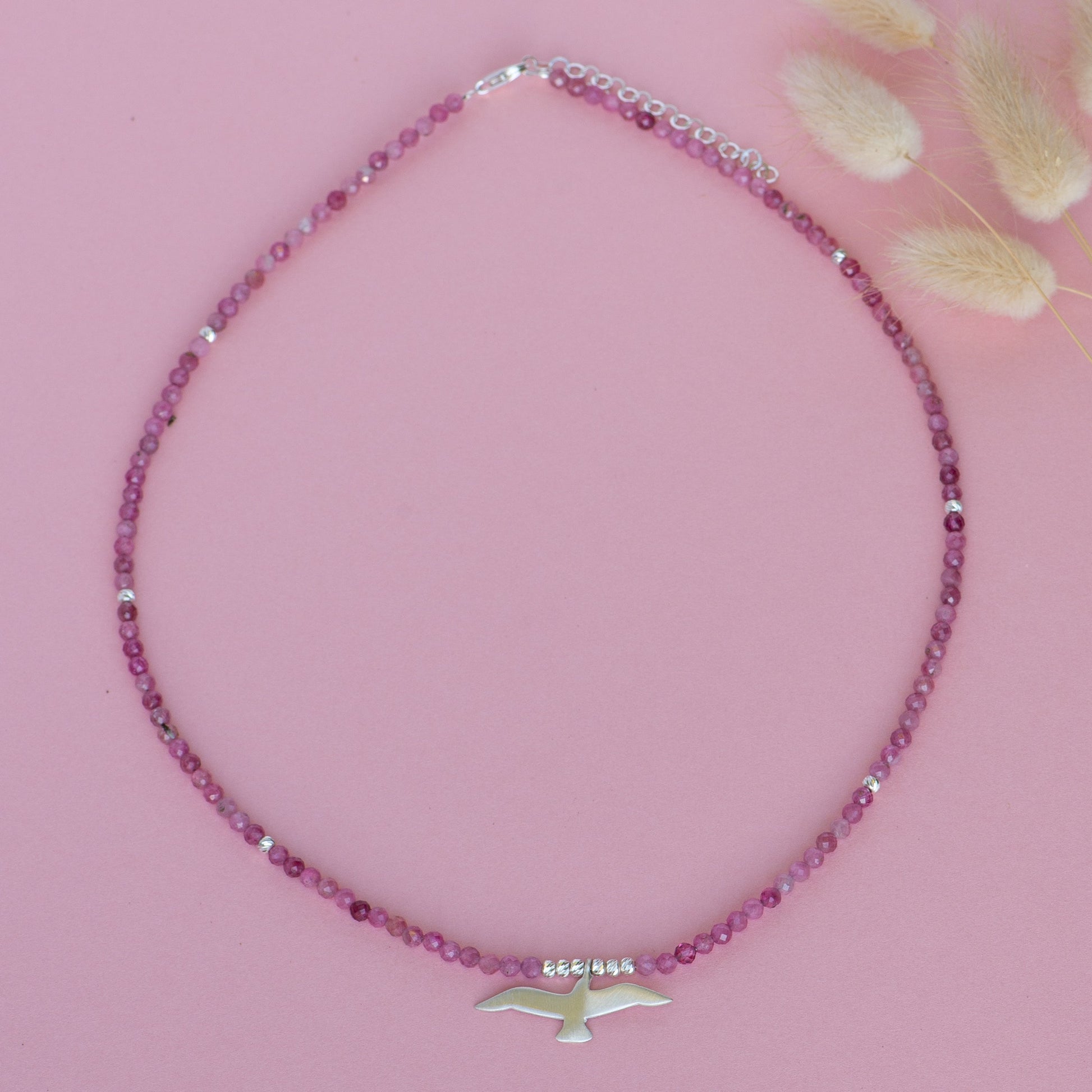 Seagull Pink Tourmaline Necklace with Delicate Beaded Design and Silver Seagull Pendant on Pink Background