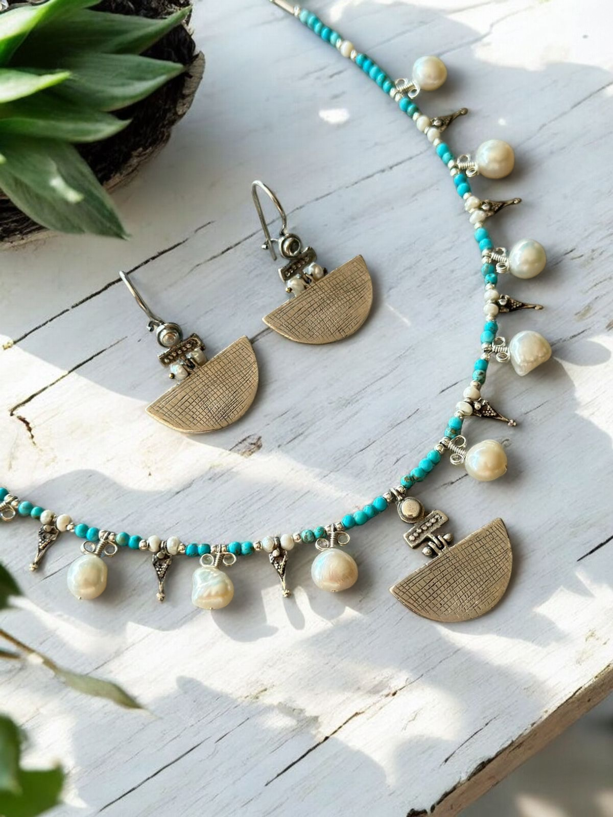 Selena Turquoise Necklace and Earrings Set featuring intricate turquoise beads, delicate pearls, and brass half-moon pendants.