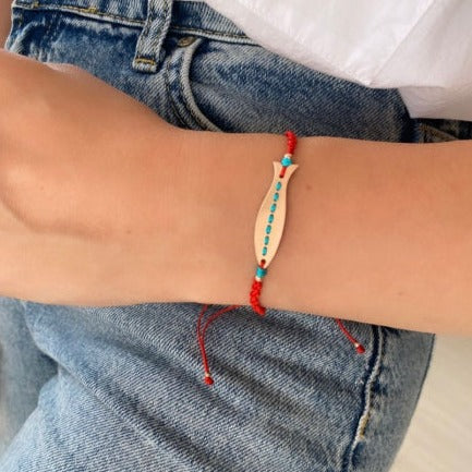 Skinny Fish Rose Gold Plated Silver Bracelet on wrist with jeans and white shirt