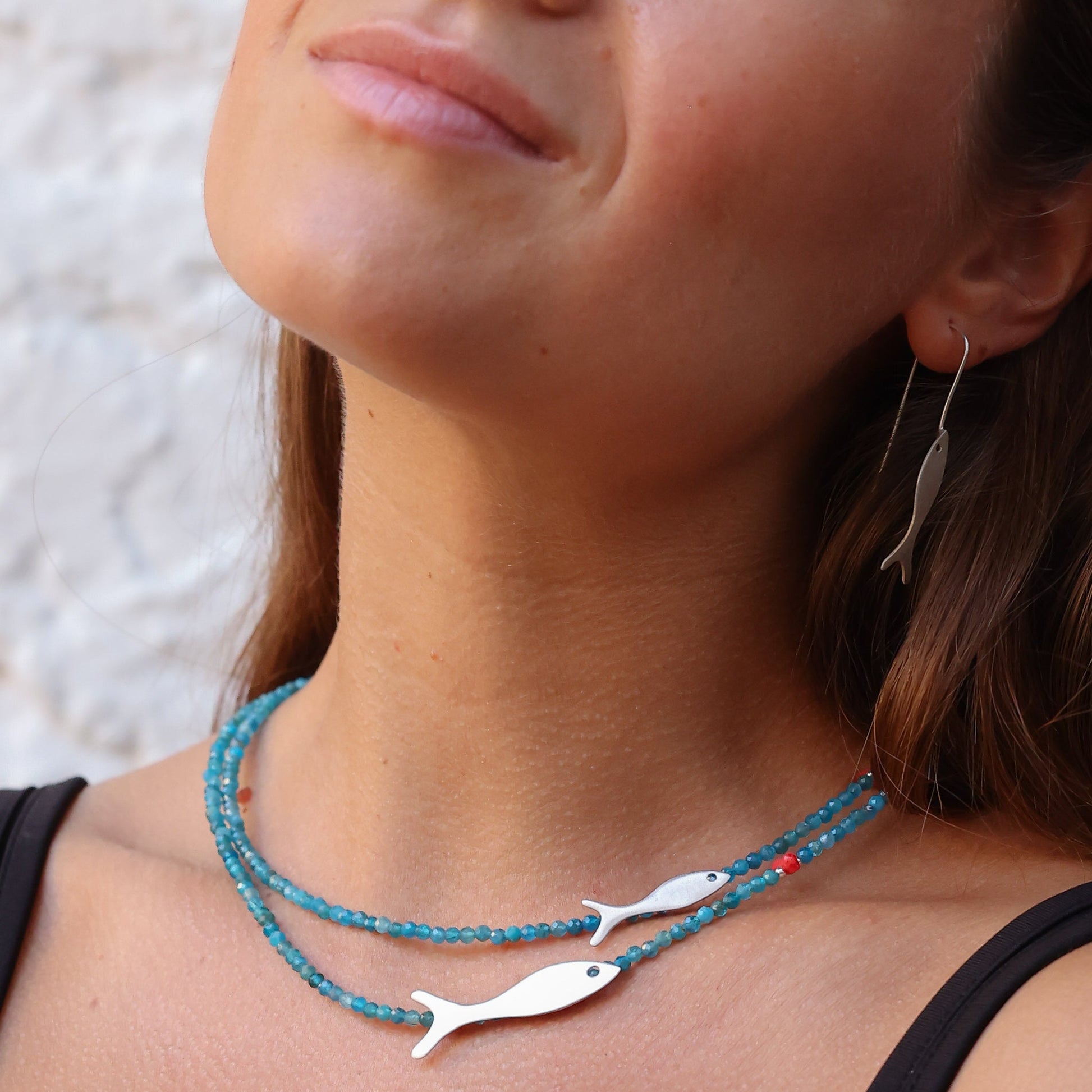 Woman wearing Small and Big Fish Apatite Silver Necklace and earrings