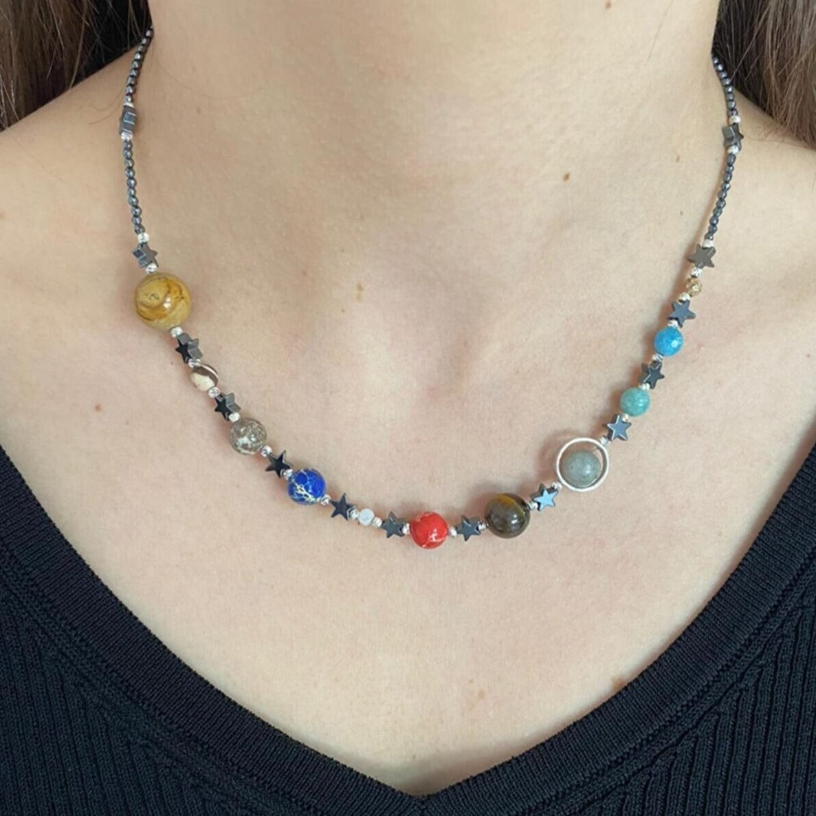 Close-up shot of a Solar System Necklace with colorful planet beads