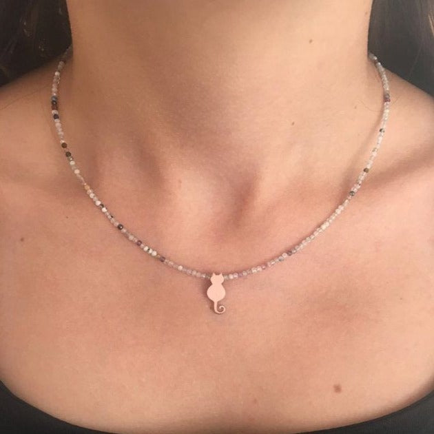 Solo Mini Cat Silver Necklace on woman’s neck with delicate beaded chain