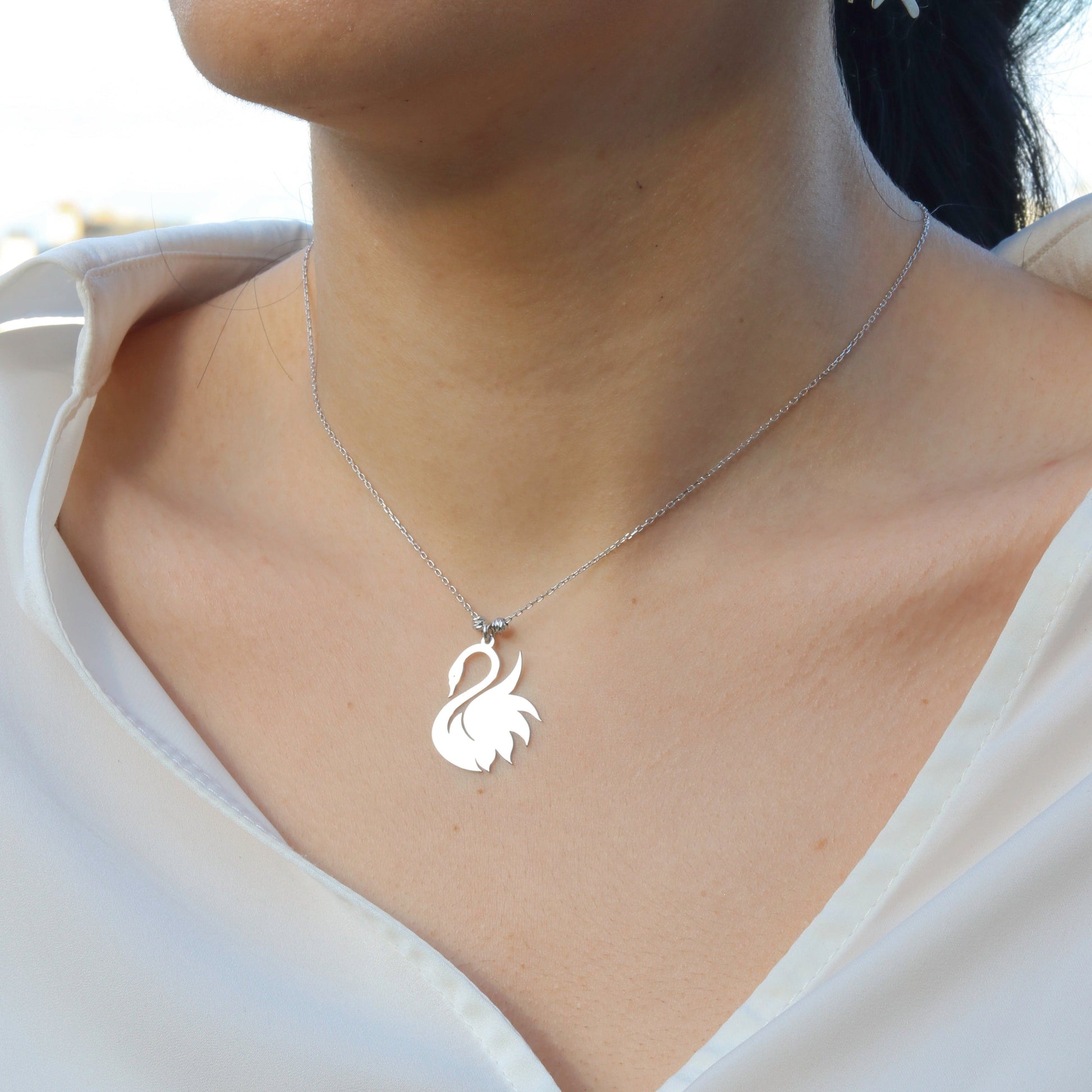 Woman wearing an elegant Swan 925 Sterling Silver Necklace