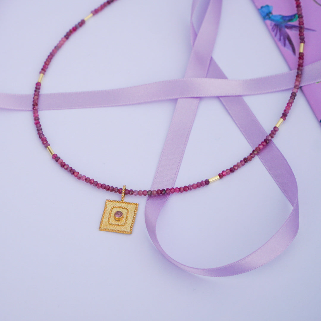 Tourmaline Gemstone Necklace with 14K Gold Plated 925 Sterling Silver Pendant, displayed on a lavender ribbon.