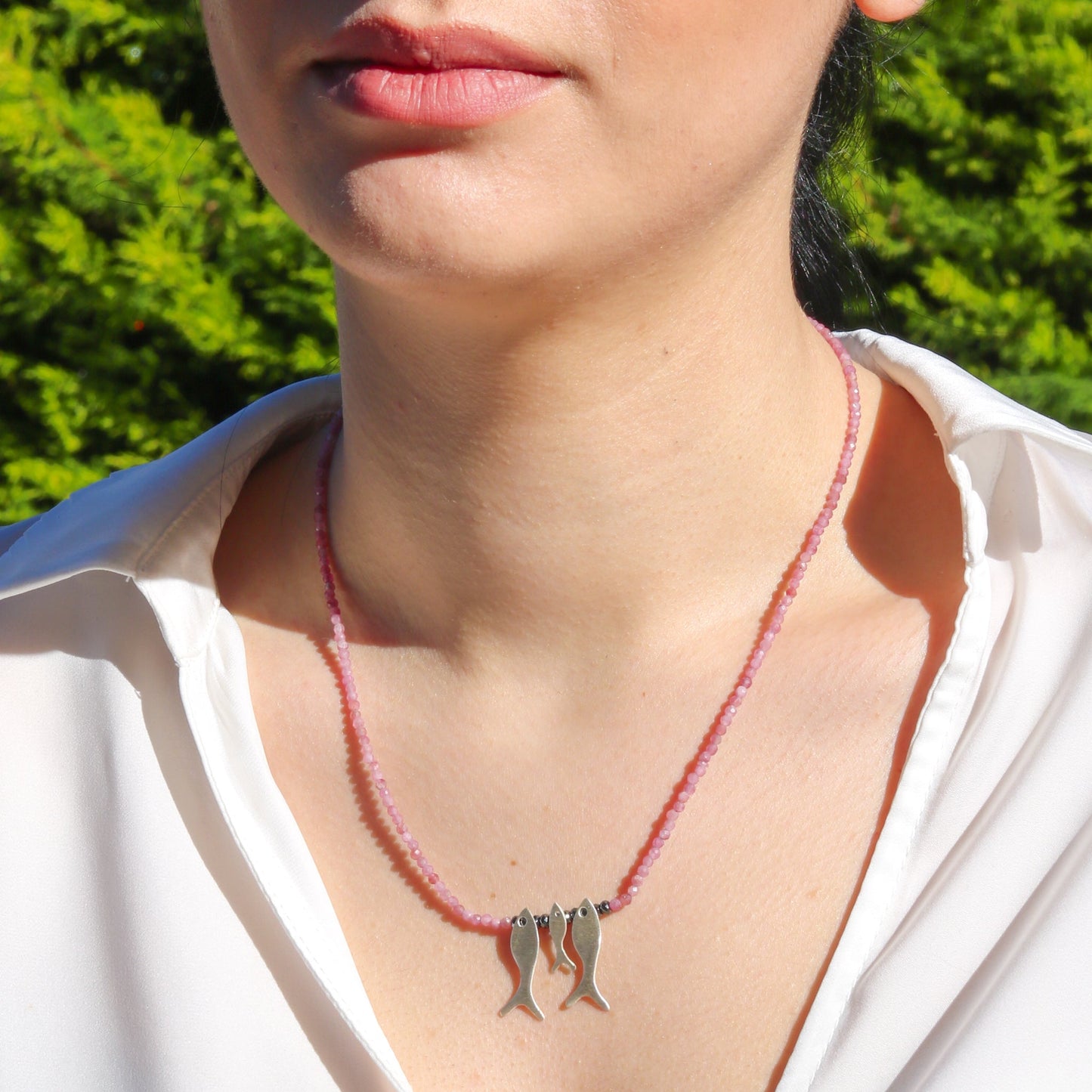 Woman wearing Trio Fish Family Pink Tourmaline Necklace