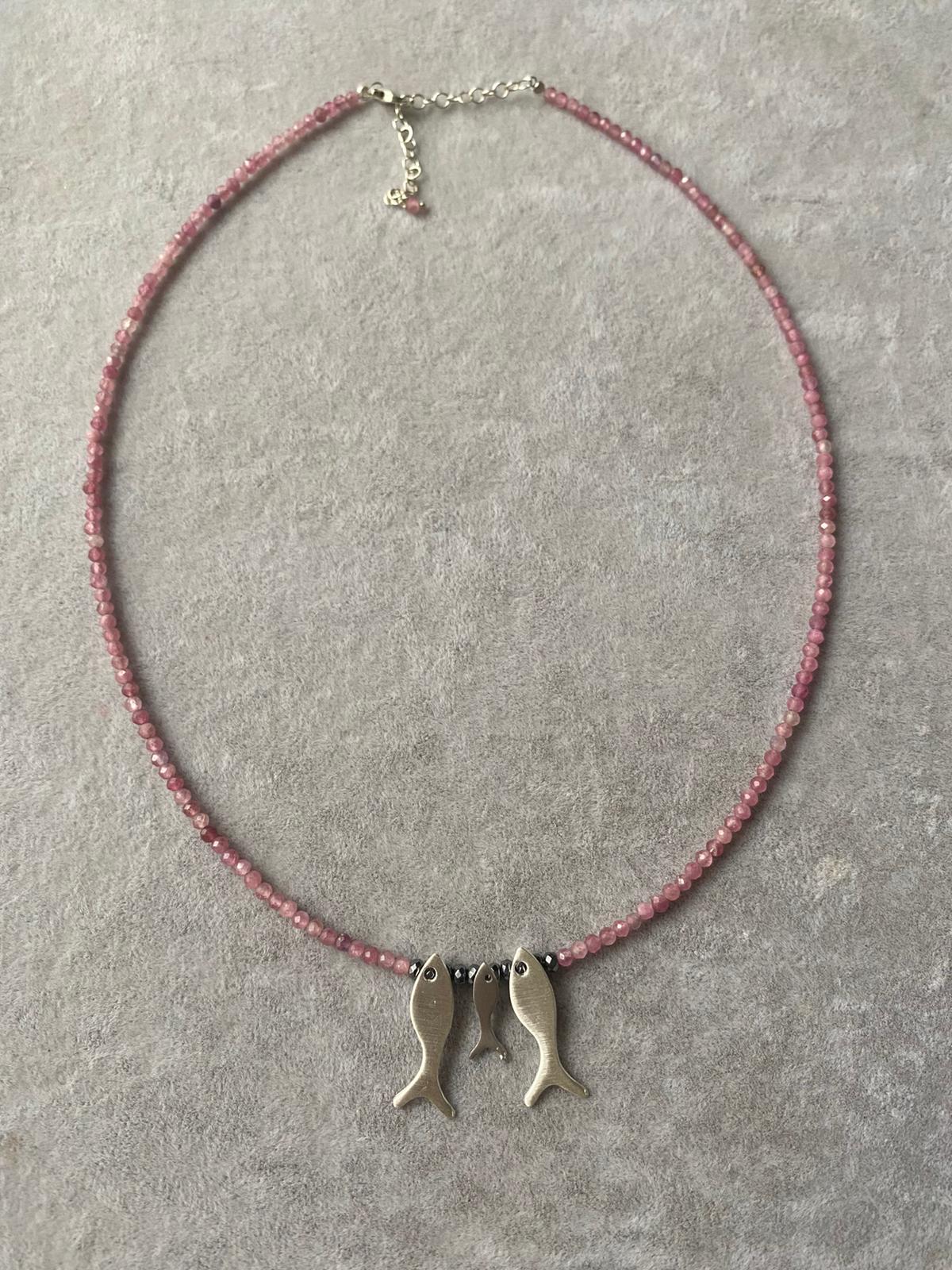 Trio Fish Family Pink Tourmaline Necklace with three silver fish pendants on a pink gemstone beaded chain.